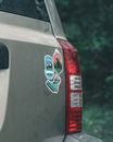White and Blue Ceramic Mug on Car Door