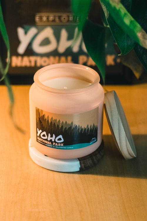 Free Aesthetic shot of a candle with Yoho National Park label on a wooden table indoors. Stock Photo