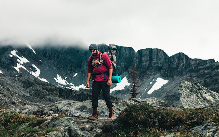 Man In Red Sweatshirt Walking On A Mountain Trail, Glacier National Park, Canada