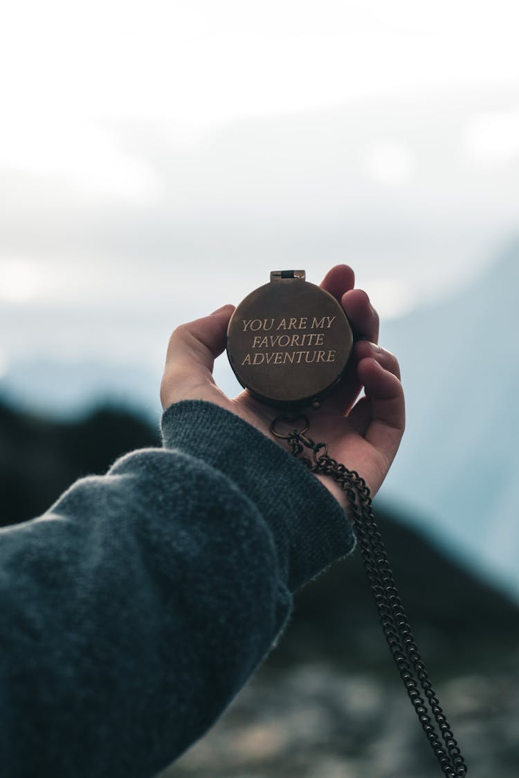 Person Holding A Pocket Watch With Inscription