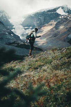 A hiker explores the stunning mountain landscapes of Jasper, Alberta, capturing wanderlust.