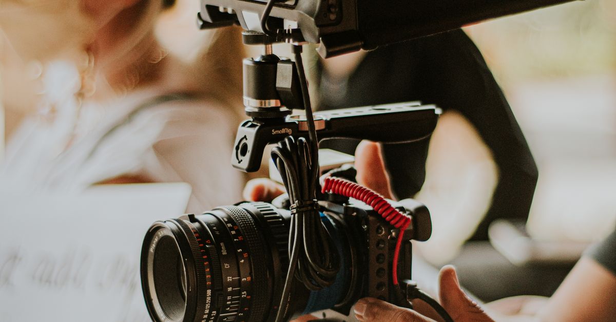 Filming Using Camera Person Filming with Professional Camera on Set · Free Stock Photo