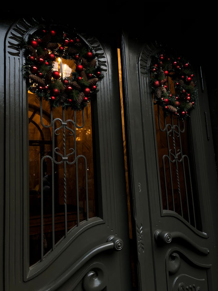 A Black Wooden Doors With Christmas Wreaths