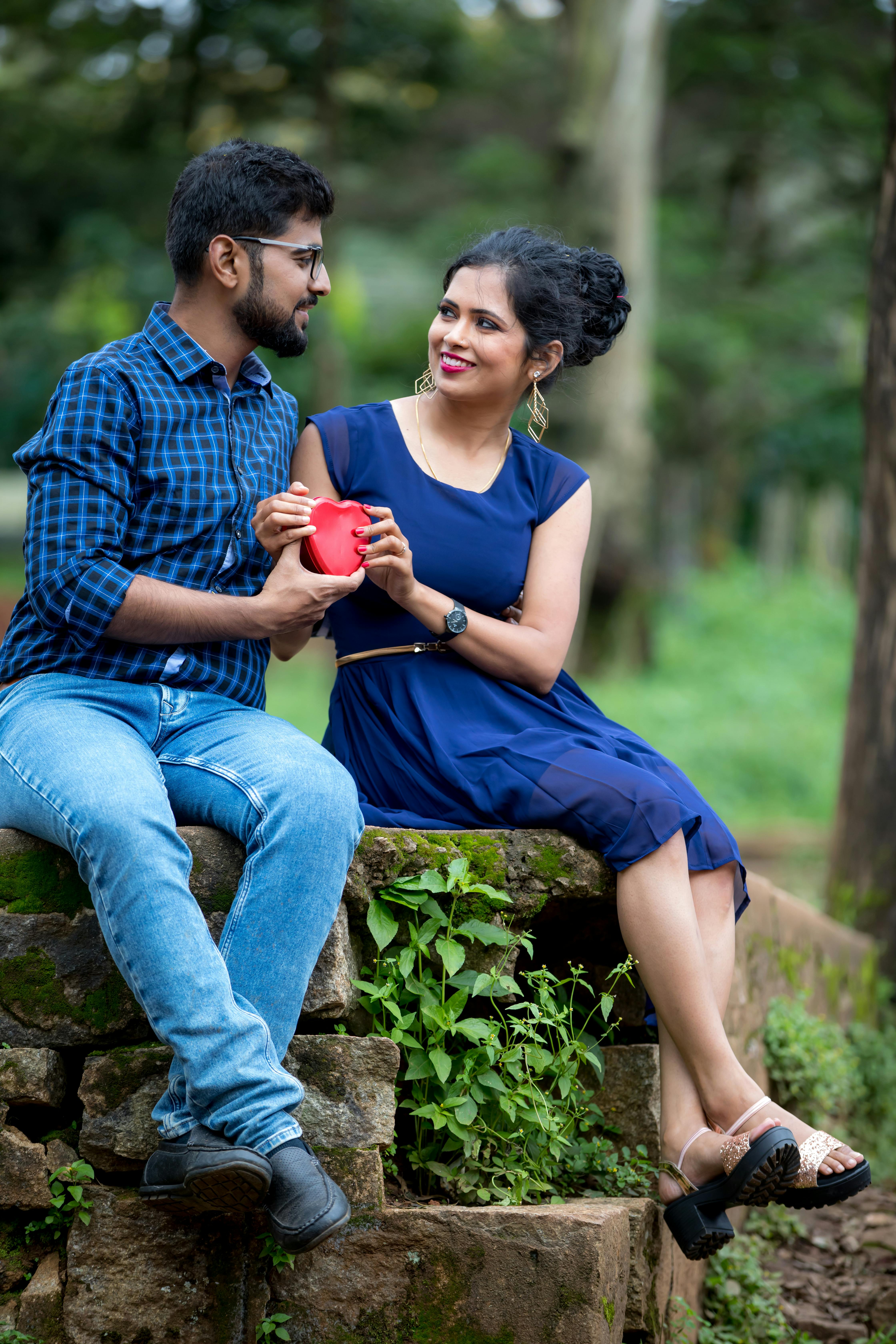 Lovely couple have fun together, sit on plaid outdoor, enjoy sunny weather,  pose for making selfie at camera Stock Photo - Alamy