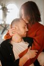 Man in Red Sweater Kissing Woman in White Tank Top