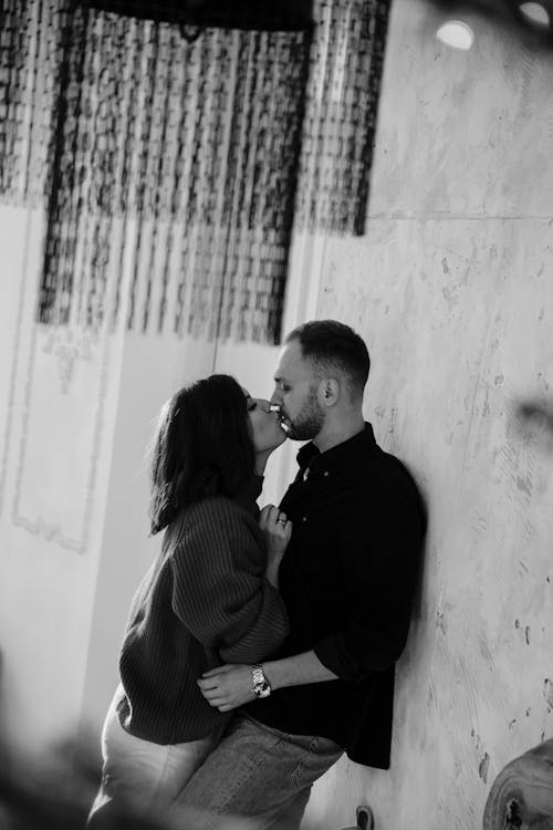 Grayscale Photo of a Couple Kissing Each Other