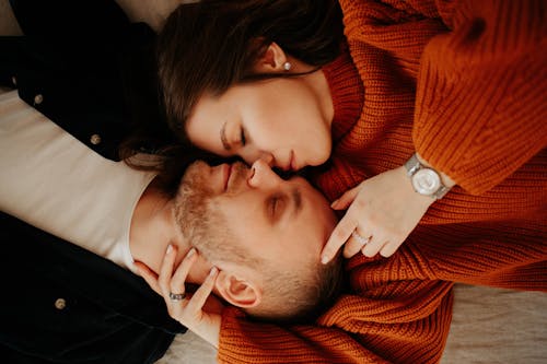 Free Couple Laying Opposite Each Other with Heads Together Stock Photo