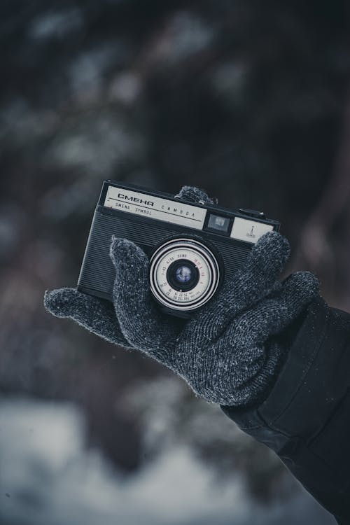 Hand in Glove Holding Camera