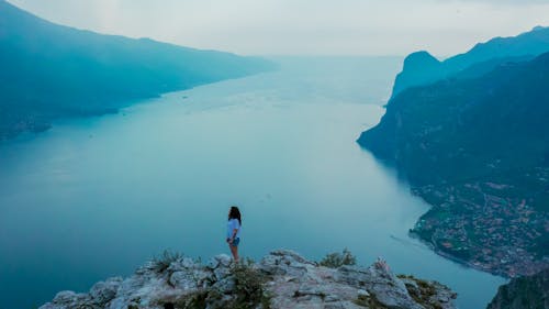 Free Woman Standing on Mountain during Dayttime Stock Photo