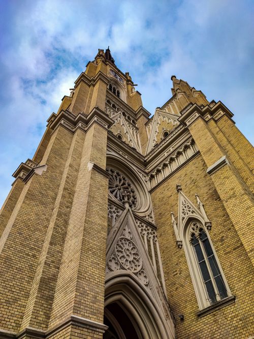 Free Low-angle view of the Gothic revival-style cathedral in Novi Sad, showcasing intricate architecture. Stock Photo