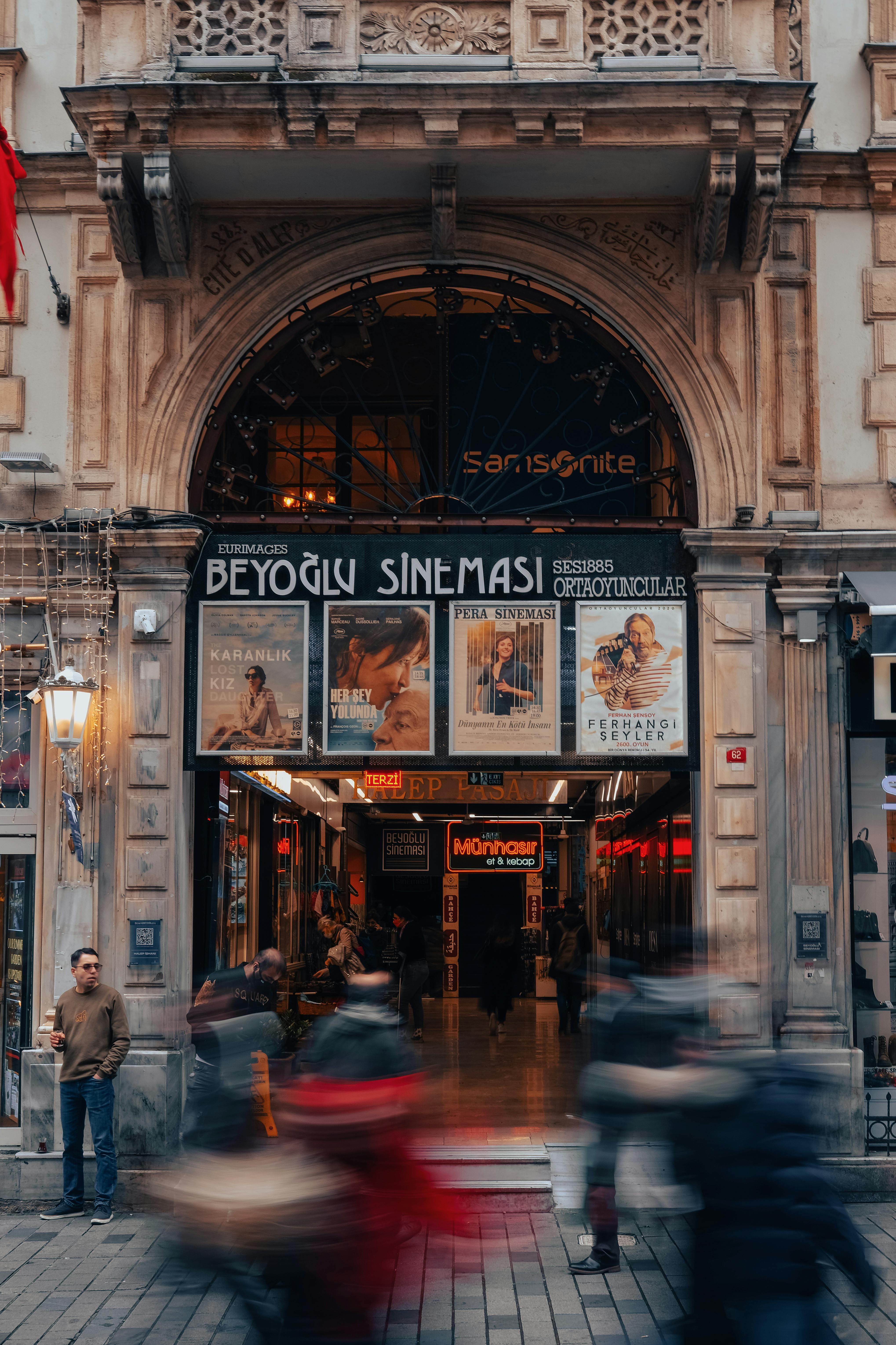 Street view of Beyoglu Sineması entrance with blurred motion of pedestrians.