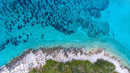 Free A breathtaking aerial view of the turquoise waters and rocky coastline in Jezerane, Croatia. Stock Photo