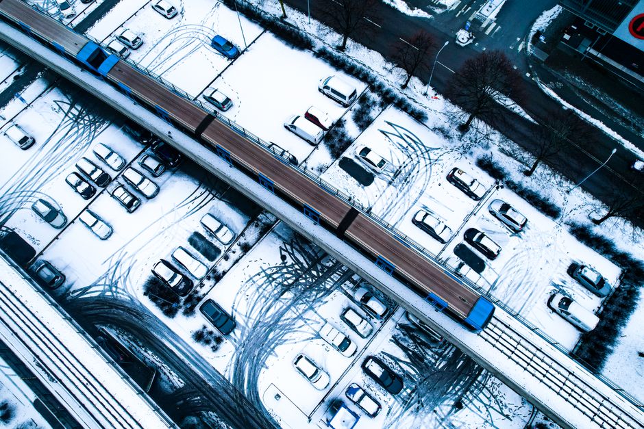 A car equipped with winter tires driving safely on a snow-covered mountain pass in Austria, near the Arlberg Tunnel