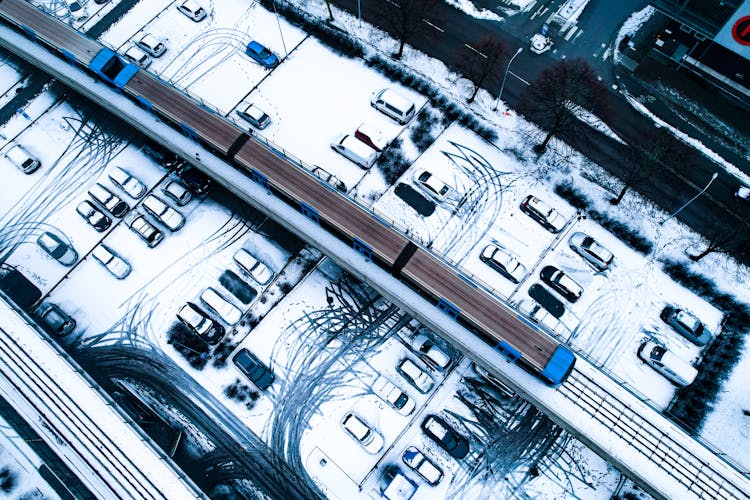 Aerial View Of Cars And A Train During Winter Season