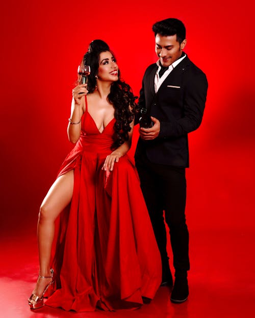 A Man in Black Suit and a Woman in Red Dress