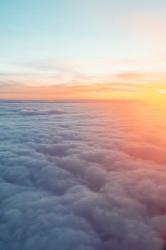 Stunning aerial view of soft clouds during a vibrant sunrise in Vancouver, Canada.
