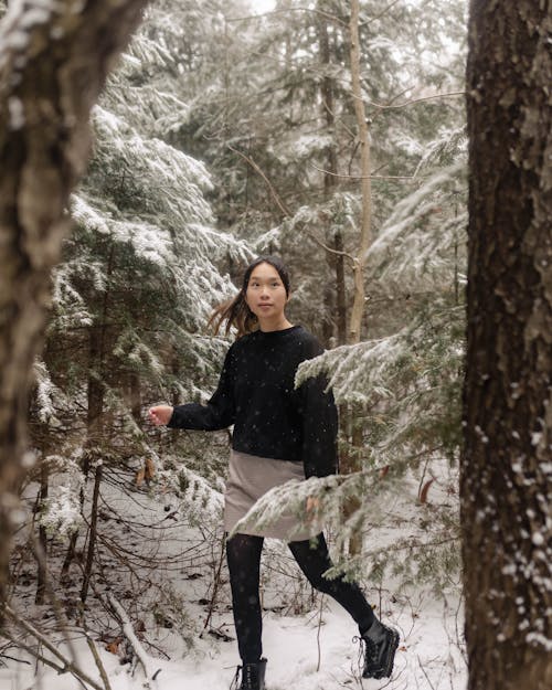 Woman Walking Through Winter Forest 