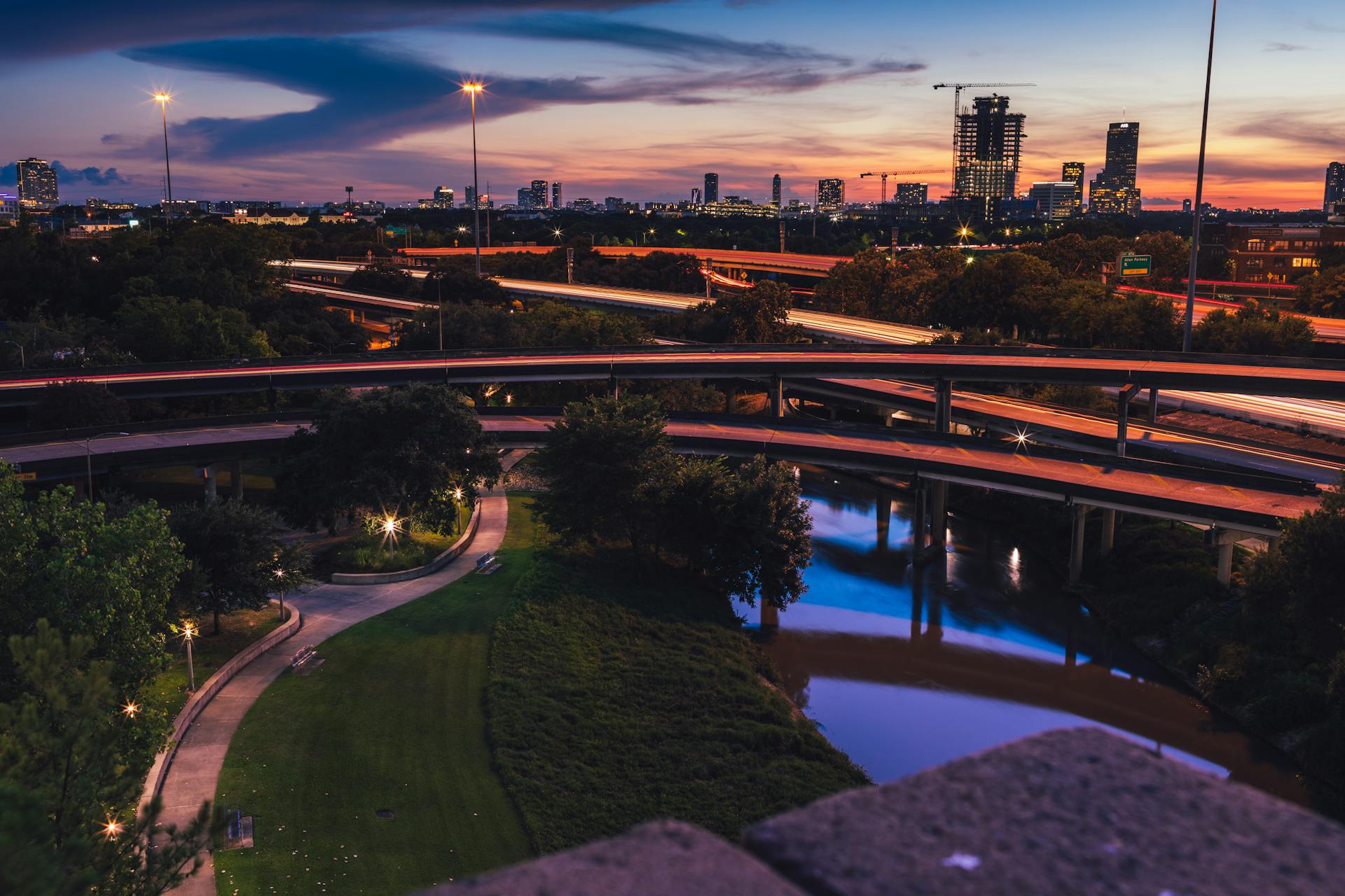 Vibrant Houston skyline at night with illuminated freeways and cityscape.