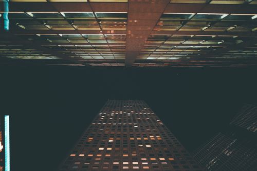 Free A striking perspective of a modern skyscraper in Houston, Texas under a night sky. Stock Photo
