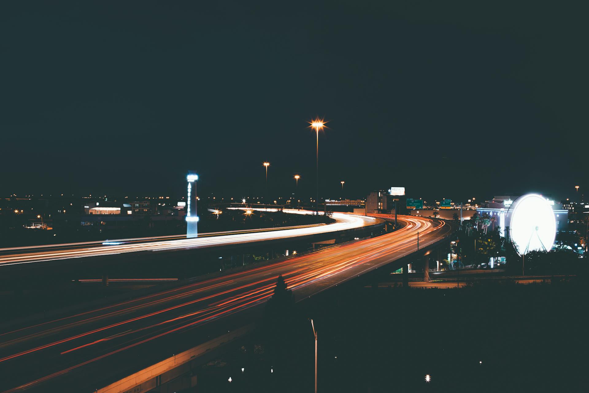 Long exposure photo capturing light trails on the highways of Houston, Texas at night.