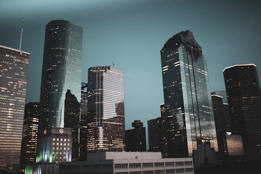 Nighttime view of Houston's modern skyline featuring illuminated skyscrapers against a dark sky.