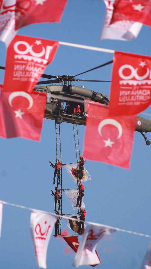 Free Military helicopter with soldiers and Turkish flags during a sky display. Stock Photo