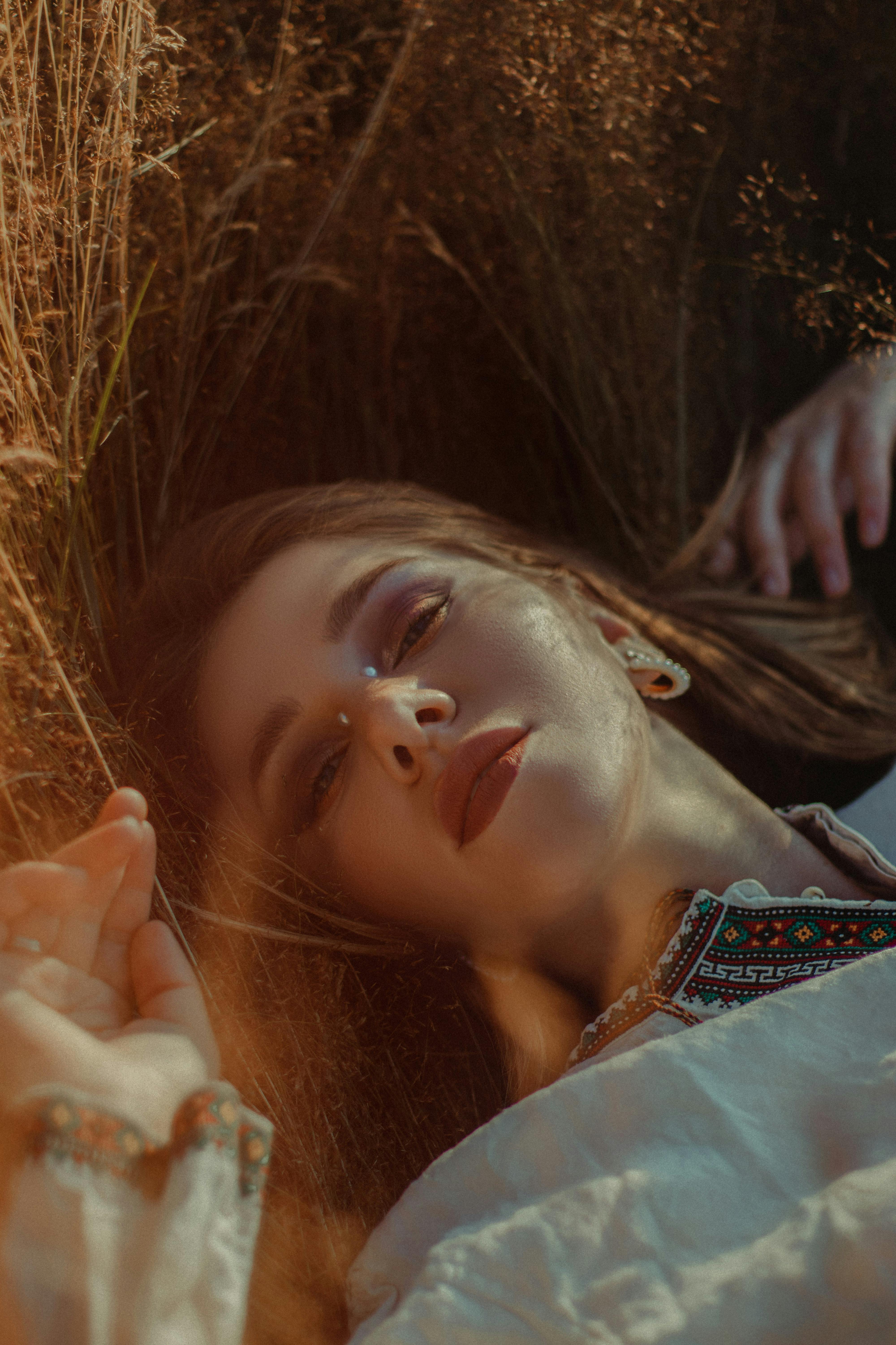 woman lying in the field of tall grass