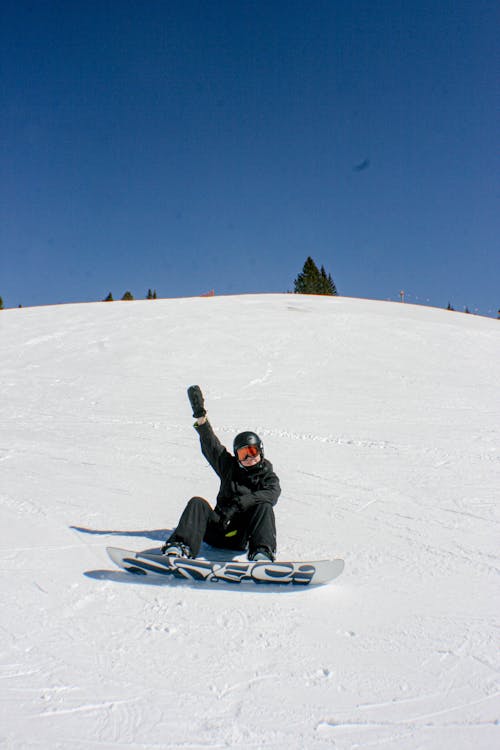 A Man in Black Jacket Riding on Snowboard · Free Stock Photo