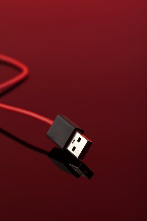 Free Usb Cable on Red Surface Stock Photo