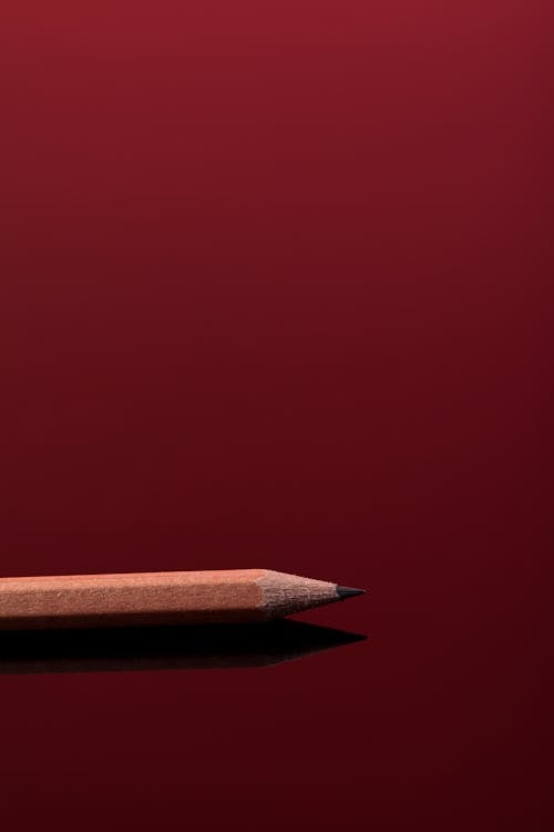Sharp Pencil on a Red Surface