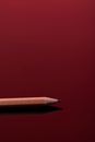 Brown Pencil on Red Surface