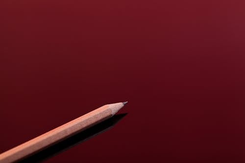 Brown Pencil on Red Surface