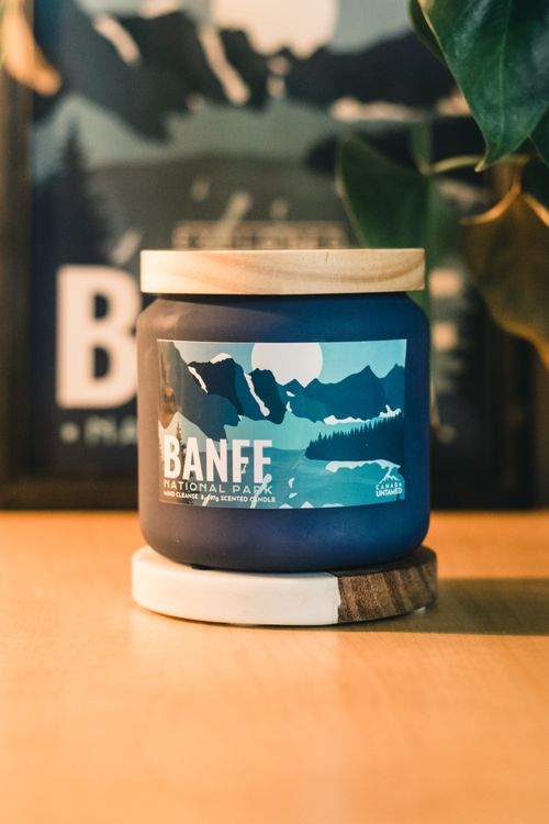 Free Close-up of a Banff National Park scented candle in a jar on a wooden surface. Stock Photo