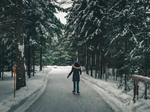 A Person Skating on Snow Covered Ground