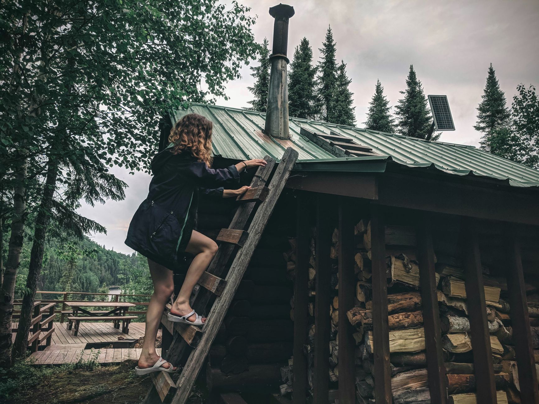 What should a roof inspection include, and what should I request in writing? Person in safety equipment climbing a ladder toward a roof for inspection