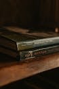 Brown Hardbound Books on a Wooden Surface