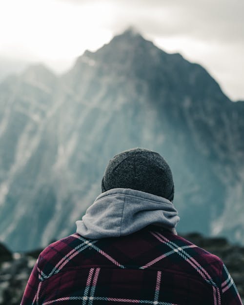 Back View of Person in Plaid Jacket Wearing Hat 