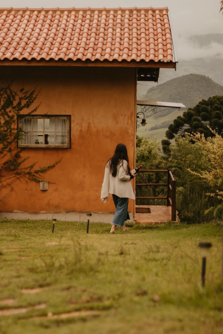 Woman Walking Near House