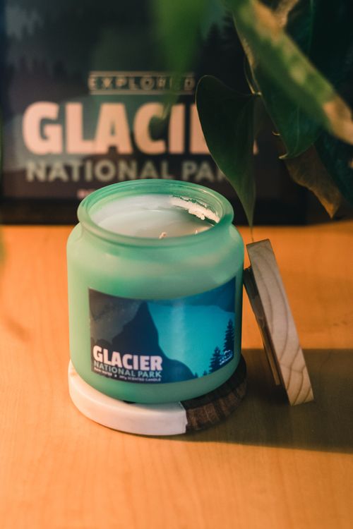 Free Green candle on wooden table with Glacier National Park label. Stock Photo