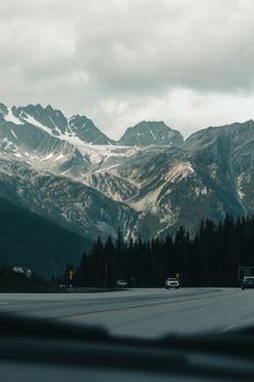 A scenic drive through the snow-capped mountains of Canada, offering a breathtaking view of the Canadian Rockies.
