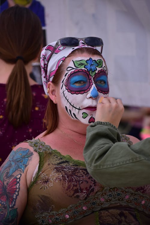 A Woman with Painting on Her Face Wearing Bandana