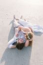 Newlywed Couple Lying on the Beach 