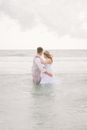Newlywed Couple Standing in the Sea