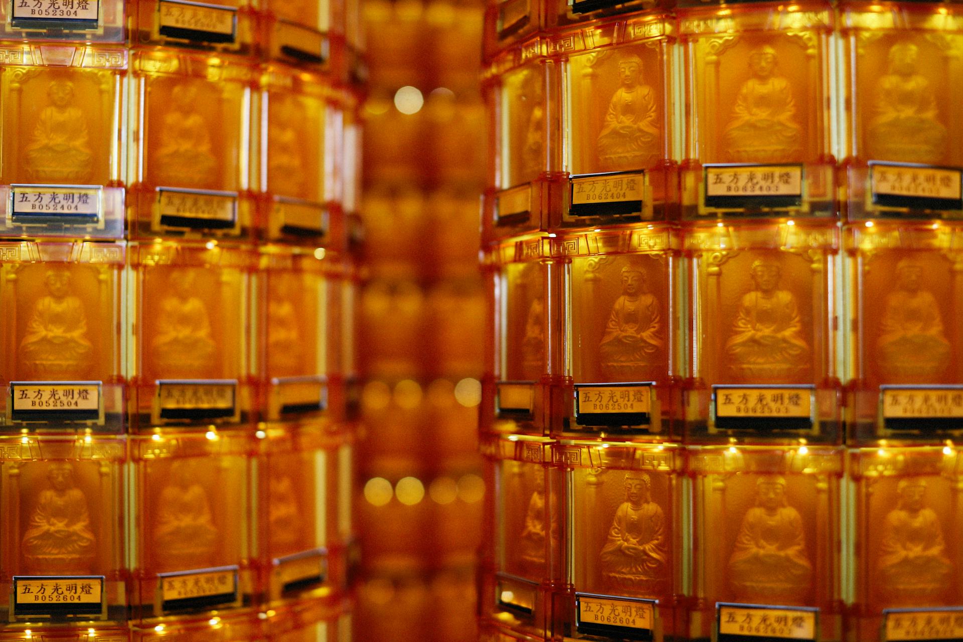 Golden Labeled Containers with Buddha Carvings