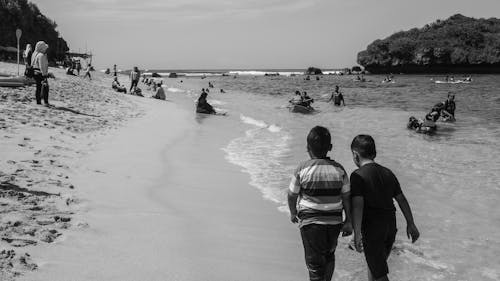 People and Children on Beach in Black and White