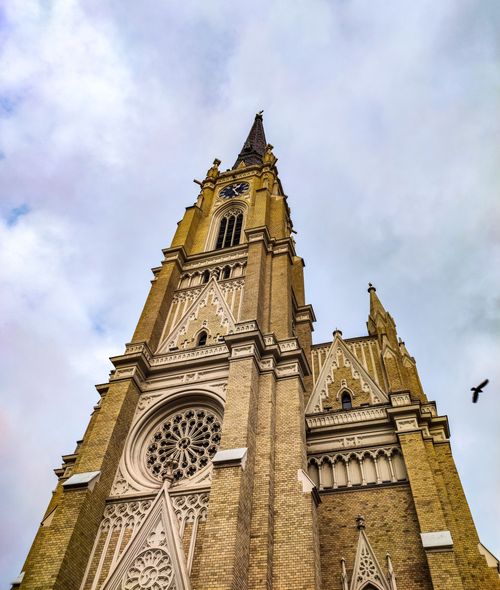 Free Low angle view of the historic Name of Mary Church against a cloudy sky in Novi Sad, Serbia. Stock Photo