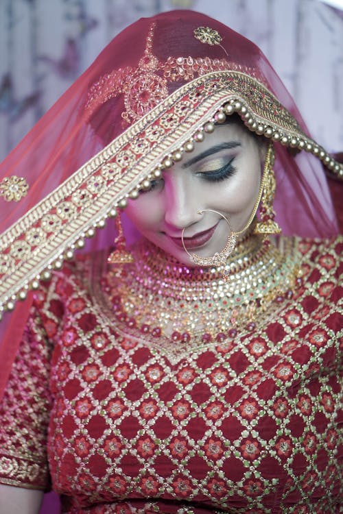 Photograph of a Woman with a Red Veil on Her Head