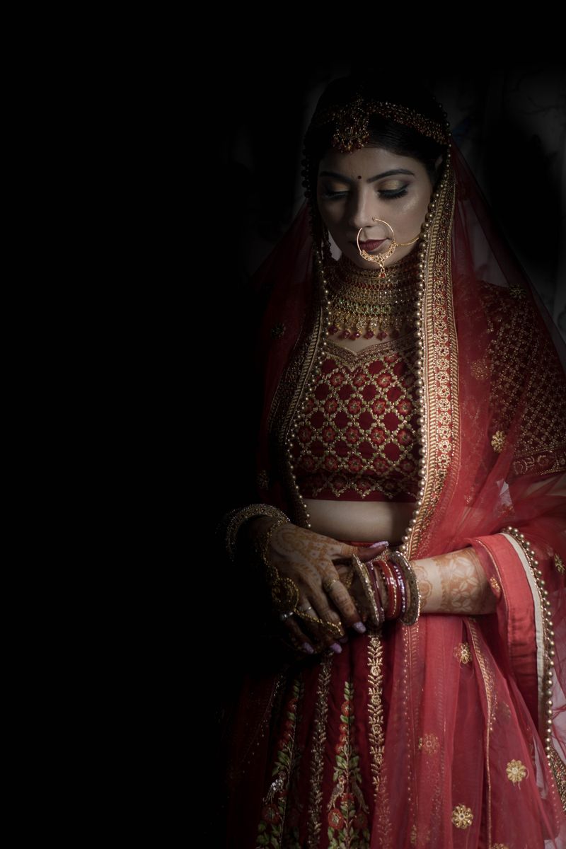 Bride in traditional red lehenga at the ceremony