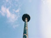 Black and White Tower Under White Clouds