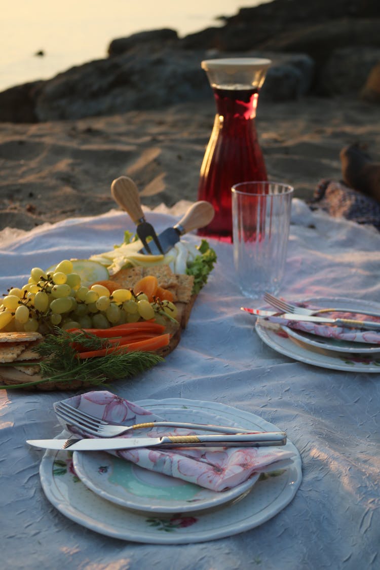 Drink, Grapes And Plates On Blanket